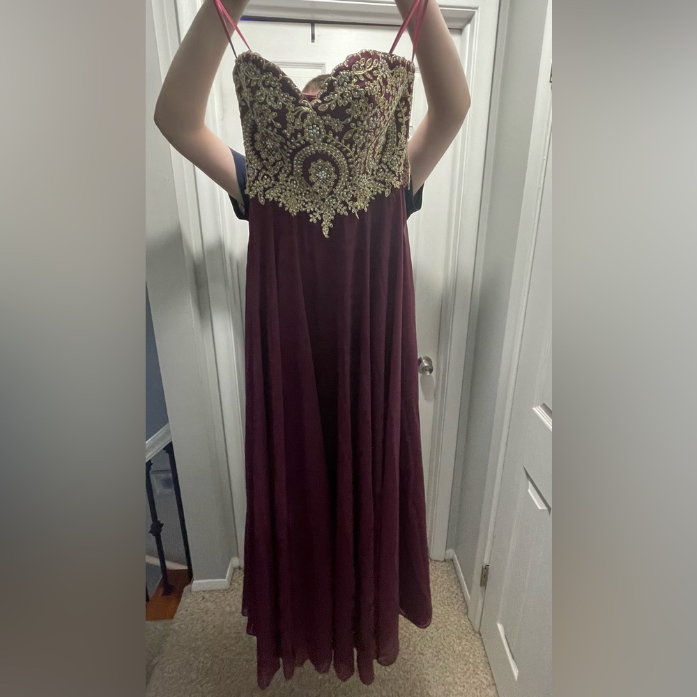 Strapless, burgundy formal dress with gold and pearl beading around the bodice.